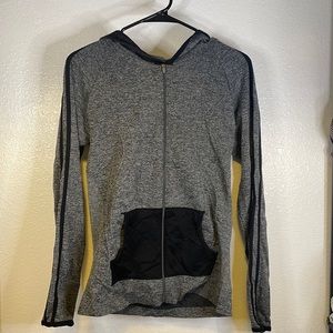 Zip up jacket with 3 strips on the sleeves.